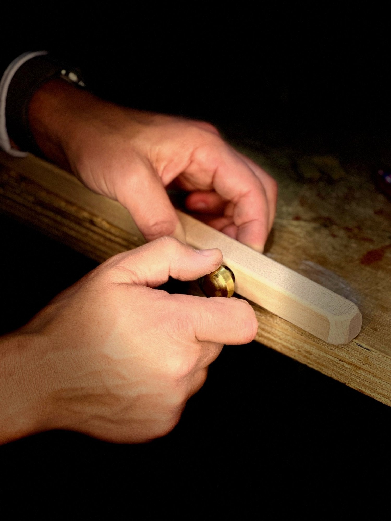 Close-up of hands holding a Nadeau Easel   to test the knob mechanism.